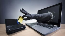 Stealing a credit card through a laptop concept for computer hacker
