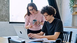 Mother and son at a computer applying for financial aid